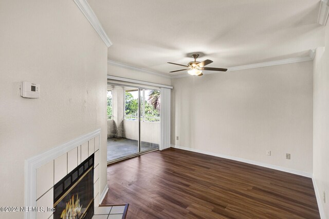 unfurnished living room featuring ceiling fan, ornamental molding, a fireplace, and dark hardwood / wood-style flooring