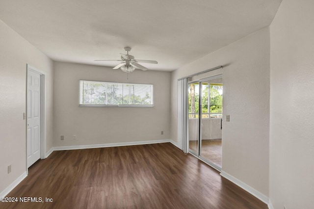 spare room featuring dark wood-type flooring and ceiling fan