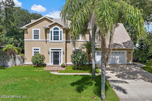 view of front of house with a garage and a front yard