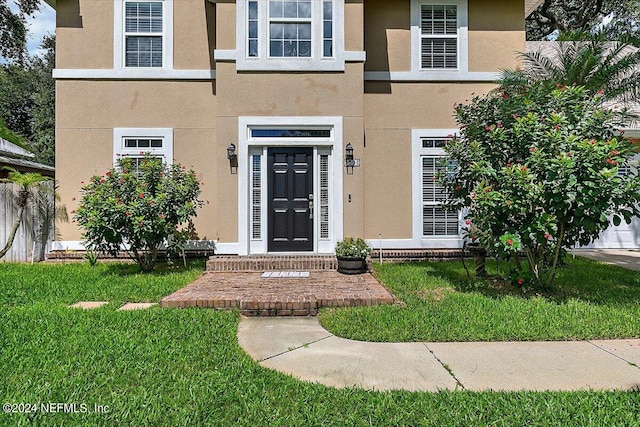 doorway to property with a yard