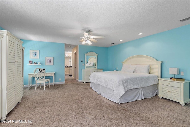 bedroom featuring light carpet, a textured ceiling, and ceiling fan