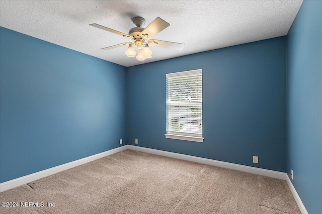 carpeted empty room with a textured ceiling and ceiling fan