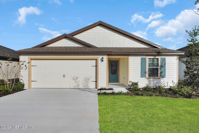 view of front of house with a garage and a front yard