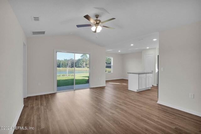 unfurnished living room featuring wood-type flooring, ceiling fan, and lofted ceiling