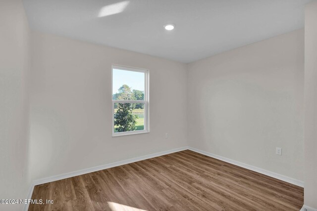 unfurnished room featuring hardwood / wood-style flooring