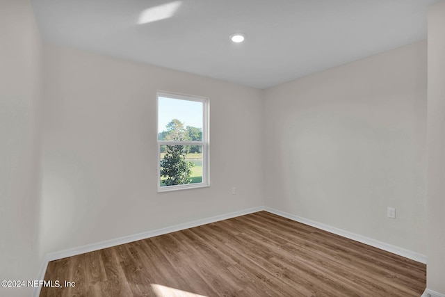 empty room with baseboards and wood finished floors