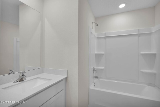 bathroom featuring vanity and tub / shower combination