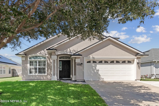 ranch-style house with a garage and a front yard