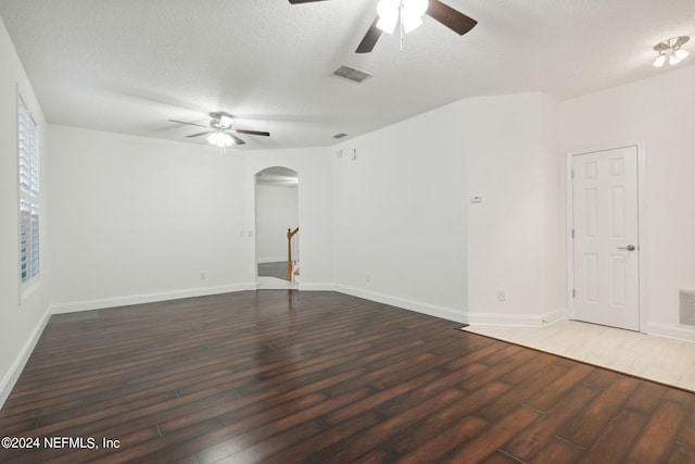 unfurnished room with dark wood-type flooring and a textured ceiling