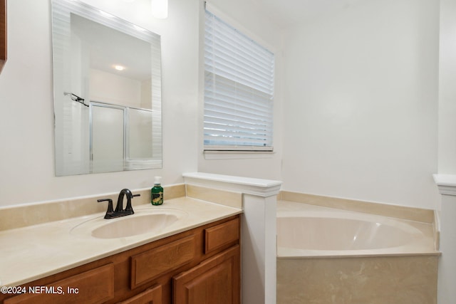 bathroom with shower with separate bathtub and vanity