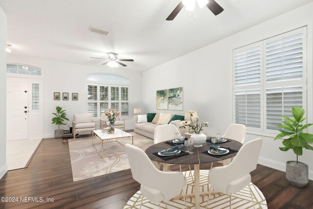 living room with ceiling fan and dark hardwood / wood-style flooring