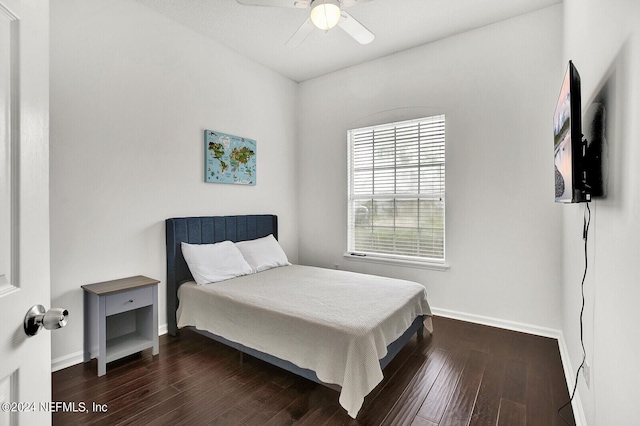 bedroom with ceiling fan and dark hardwood / wood-style floors