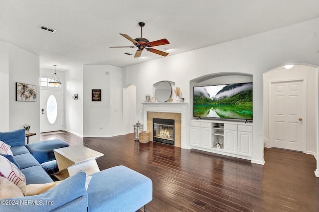 living room featuring dark hardwood / wood-style flooring and ceiling fan