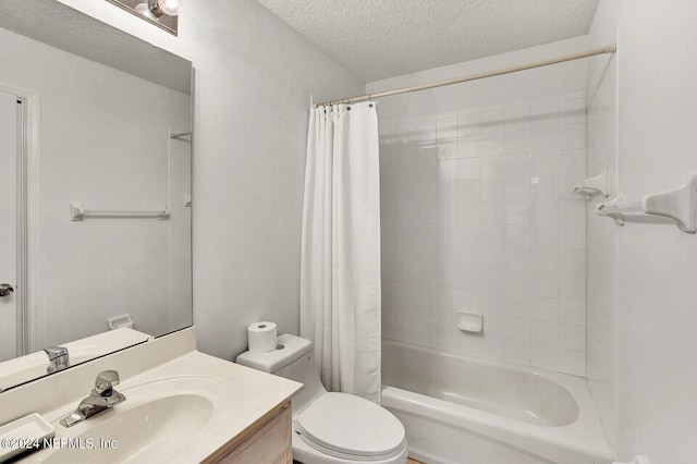 full bathroom featuring shower / bath combo with shower curtain, vanity, toilet, and a textured ceiling