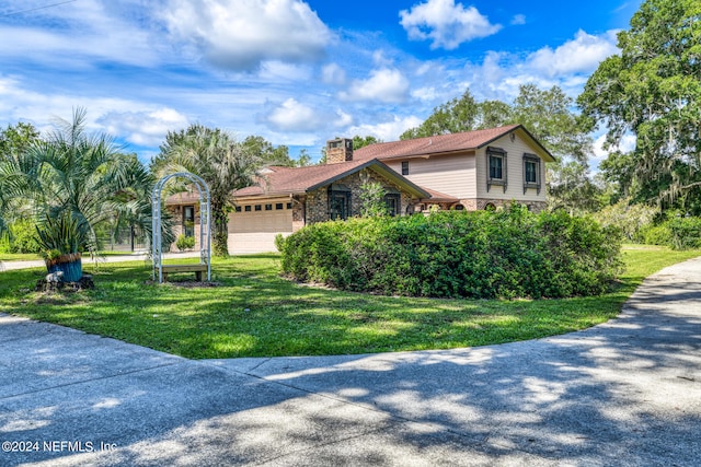 view of front of property featuring a garage and a front lawn