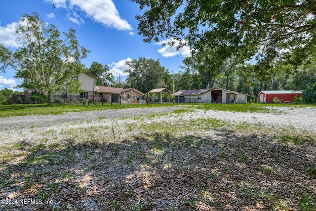 view of yard with fence and an outdoor structure