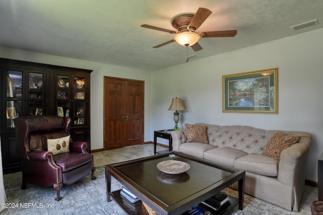 living room with light tile patterned floors and ceiling fan