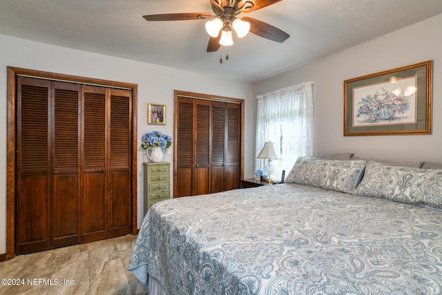 bedroom featuring a ceiling fan and multiple closets