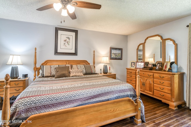 bedroom featuring ceiling fan, dark hardwood / wood-style floors, and a textured ceiling