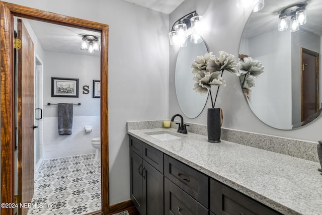 bathroom featuring vanity, toilet, and tile patterned floors