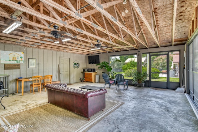 interior space with a ceiling fan and concrete flooring