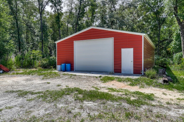 detached garage featuring a wooded view