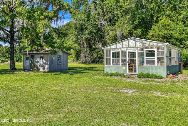 view of yard with a greenhouse and an outdoor structure