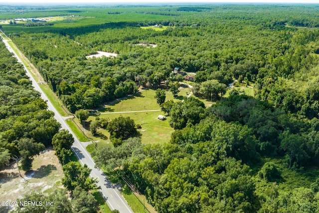 drone / aerial view featuring a forest view