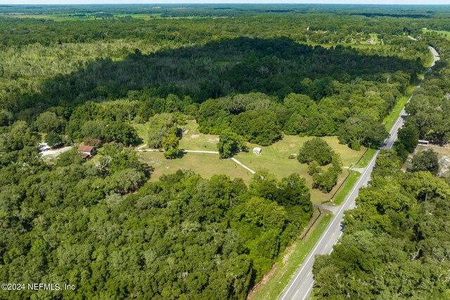 drone / aerial view with a wooded view