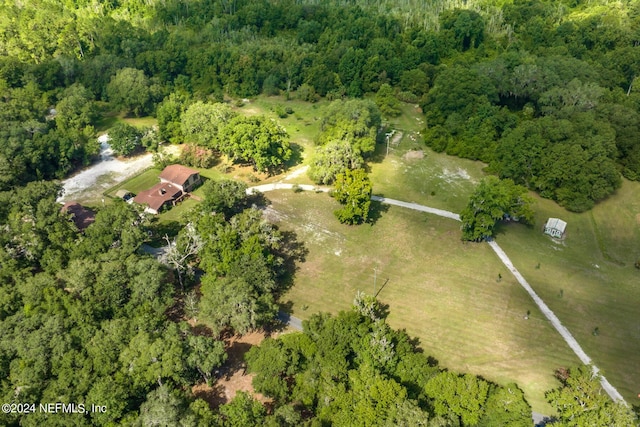 drone / aerial view with a wooded view