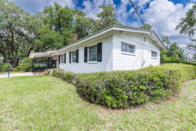 view of property exterior featuring a lawn