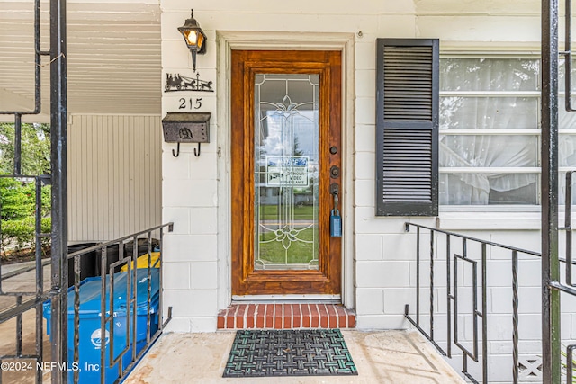 property entrance featuring concrete block siding