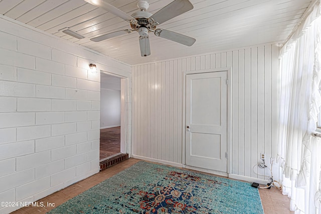 tiled empty room featuring a ceiling fan