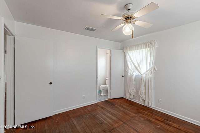 unfurnished bedroom with ceiling fan, visible vents, baseboards, hardwood / wood-style floors, and ensuite bath