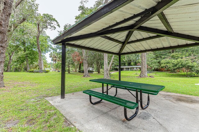 view of home's community featuring a patio area, a gazebo, and a lawn