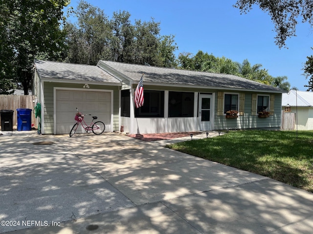 ranch-style home with a garage and a front lawn