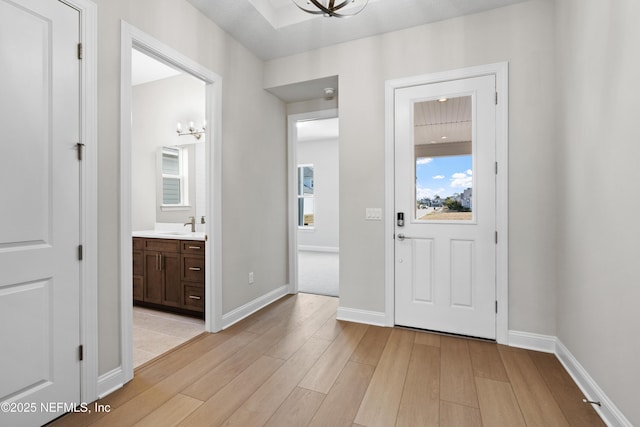 foyer with sink and light wood-type flooring