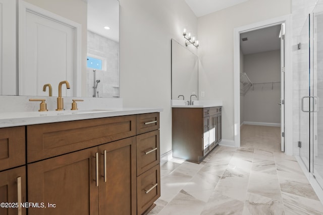 bathroom with a shower with door and vanity