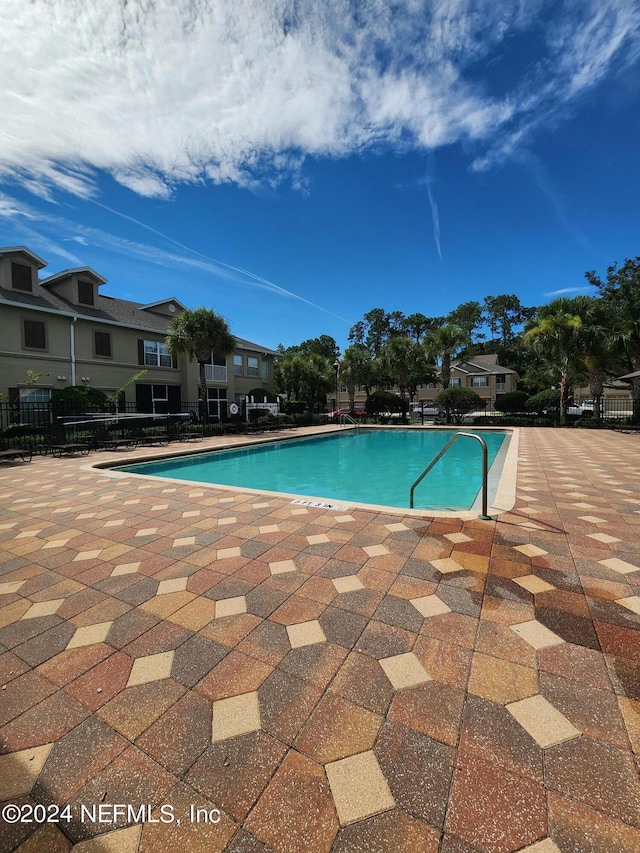 view of swimming pool featuring a patio area