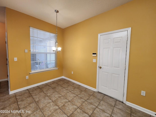 unfurnished dining area with a chandelier and tile patterned floors