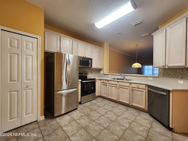 kitchen featuring appliances with stainless steel finishes, light tile patterned floors, decorative backsplash, sink, and decorative light fixtures