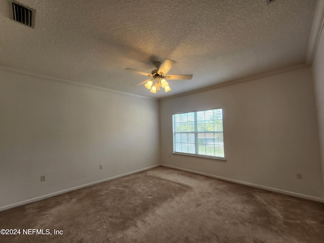 carpeted empty room featuring ceiling fan, ornamental molding, and a textured ceiling