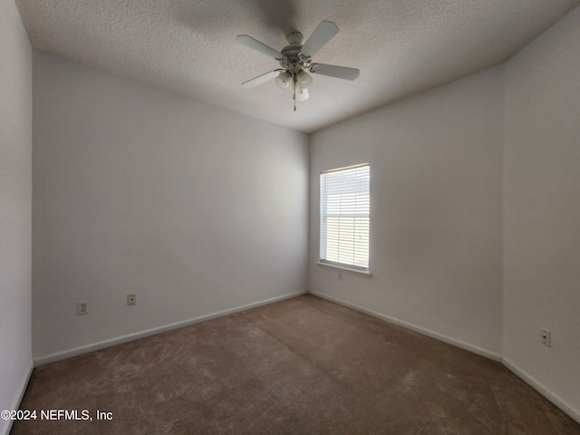 carpeted empty room featuring a textured ceiling and ceiling fan