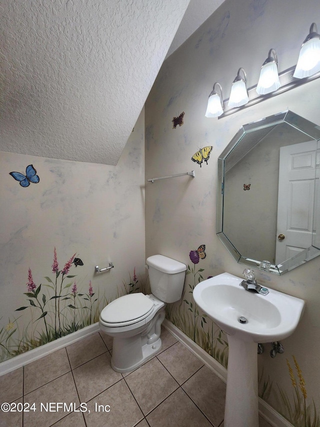 bathroom featuring toilet, tile patterned flooring, and sink