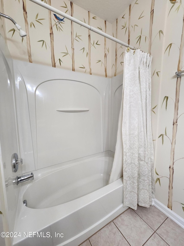 bathroom with shower / bathtub combination with curtain and tile patterned floors