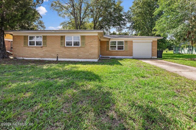 single story home featuring a garage and a front yard