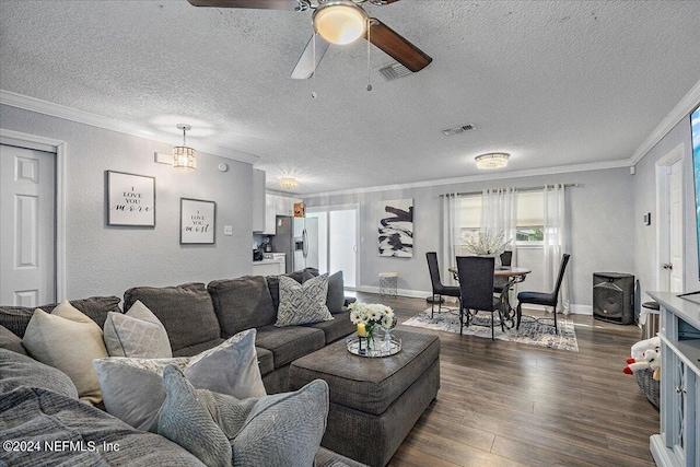 living room featuring dark wood-type flooring, ceiling fan, ornamental molding, and a textured ceiling