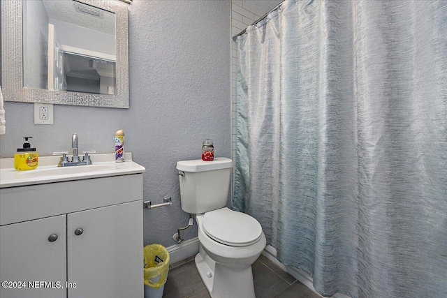 bathroom with tile patterned flooring, vanity, a shower with shower curtain, and toilet