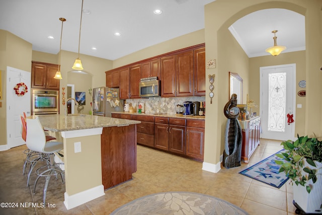 kitchen with decorative light fixtures, light tile patterned floors, tasteful backsplash, and stainless steel appliances