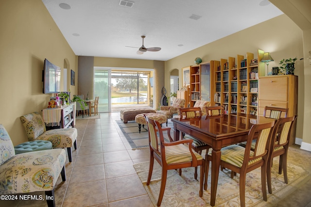 tiled dining space featuring ceiling fan